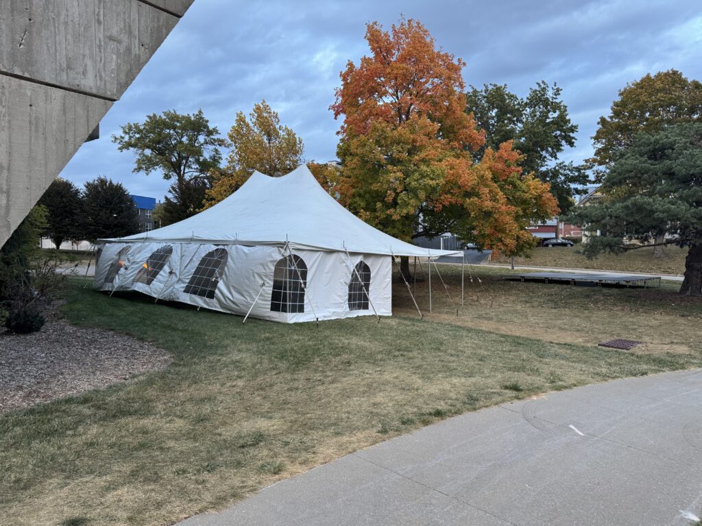 30' x 40' rope and pole event tent with a 16' x 20' stage at University of Iowa College of Dentistry for Homecoming.