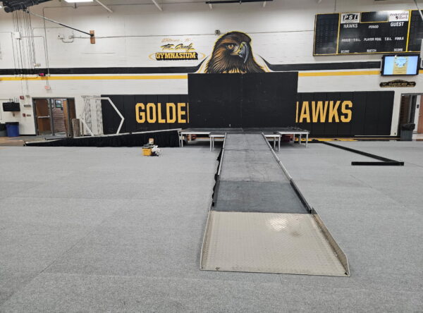 Temporary stage with ramps in the gymnasium at Mid Prairie High School in Wellman, IA Temporary stage with ramps in the gymnasium at Mid Prairie High School in Wellman, IA