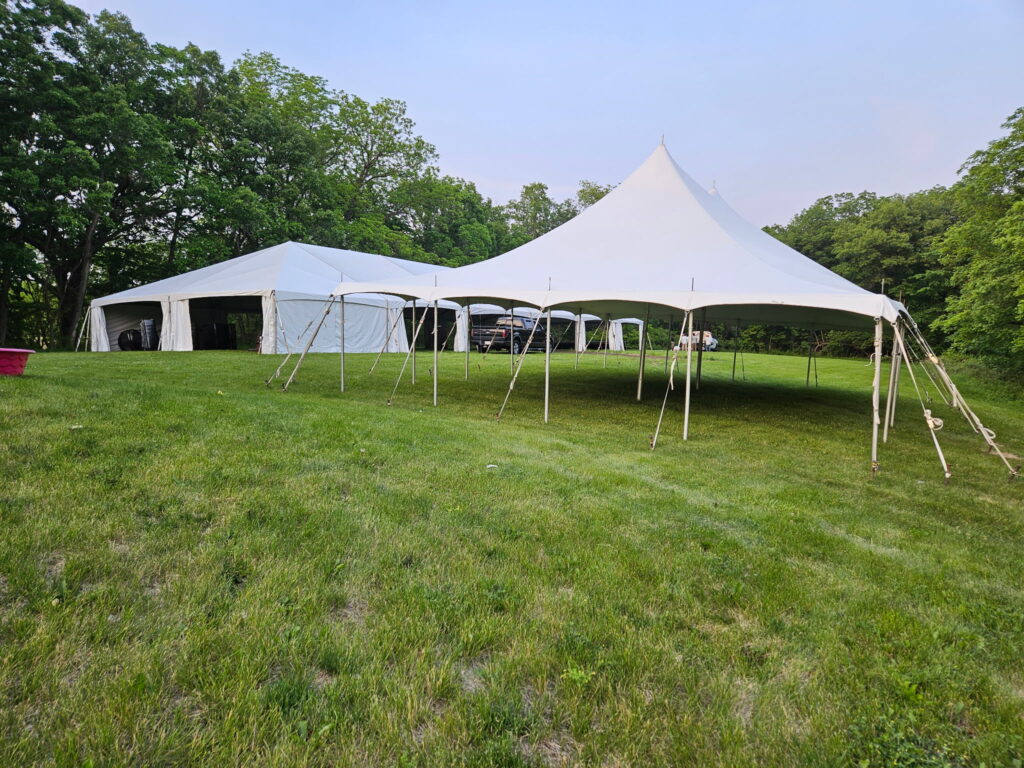30' x 45' rope and pole tent with a 40' x 120' Hybrid Jumbo Track Tent in the background at Quad City Hindu Temple in Rock Island, Illinois