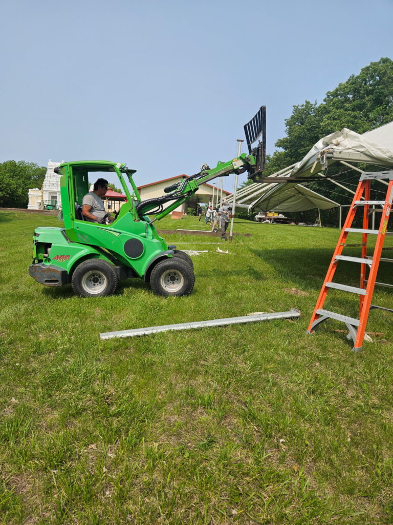 The Avant 635 and crew setting up the 40' X 120' Jumbo Trak Hybrid Tent used as a Sabha Education Tent at Quad City Hindu Temple in Rock Island, Illinois