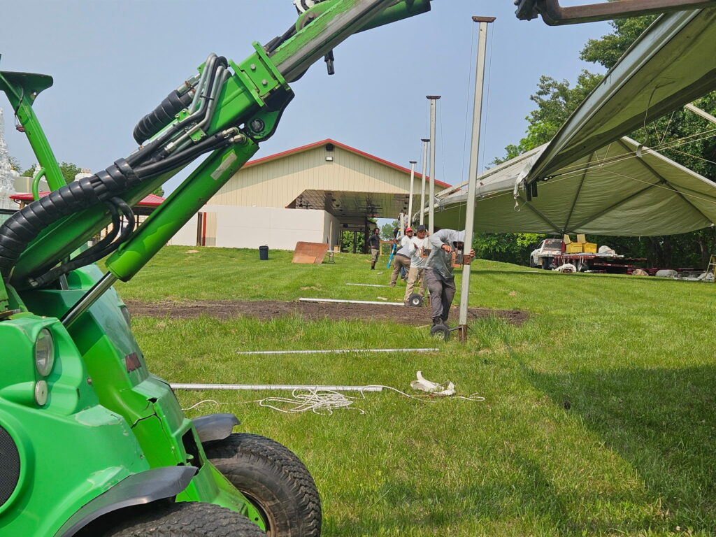 The crew setting up the 40' X 120' Jumbo Trak Hybrid Tent used as a Sabha Education Tent at Quad City Hindu Temple in Rock Island, Illinois