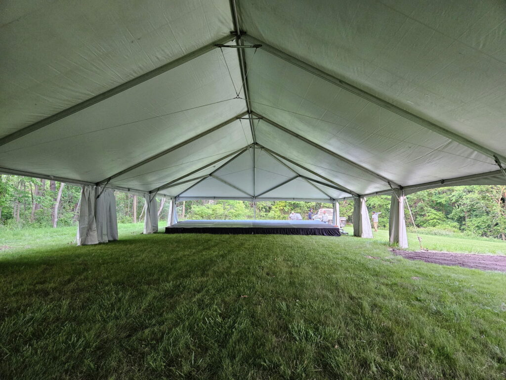 Under the 40' x 120' Hybrid Jumbo Track Tent with stage at the end at Quad City Hindu Temple in Rock Island, Illinois