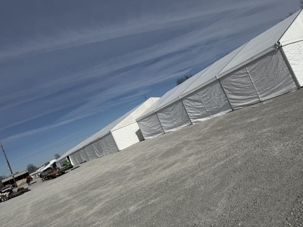 60' x 230' (18m x 70m) Losberger clearspan on the left and 49' x 66' (15m x 20m) Liri Clearspan tent on the right in Kalona, Iowa - Kalona Special Workhorse Sale
