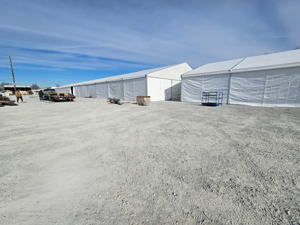 60' x 230' (18m x 70m) Losberger clearspan on the left and 49' x 66' (15m x 20m) Liri Clearspan tent on the right in Kalona, Iowa