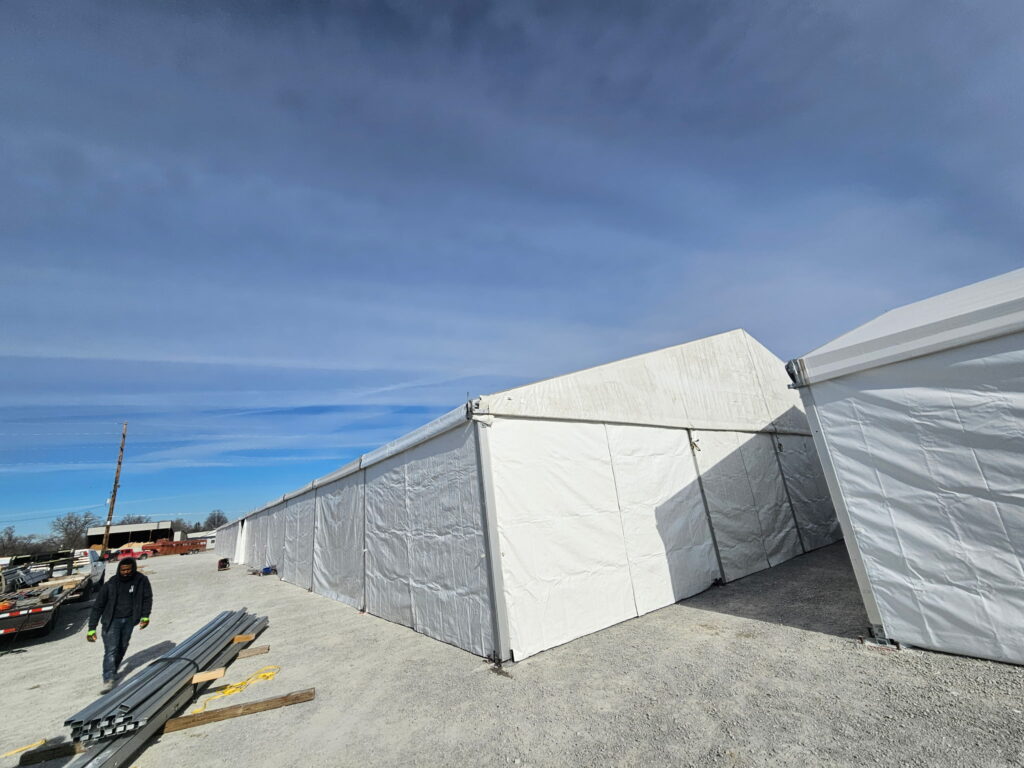 60' x 230' (18m x 70m) Losberger clearspan on the left and part of the 49' x 66' (15m x 20m) Liri clearspan tent on the right in Iowa.