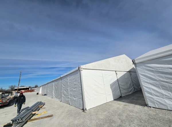 60' x 230' (18m x 70m) Losberger clearspan on the left and part of the 49' x 66' (15m x 20m) Liri clearspan tent on the right in Iowa. 60' x 230' (18m x 70m) Losberger clearspan on the left and part of the 49' x 66' (15m x 20m) Liri clearspan tent on the right in Iowa.