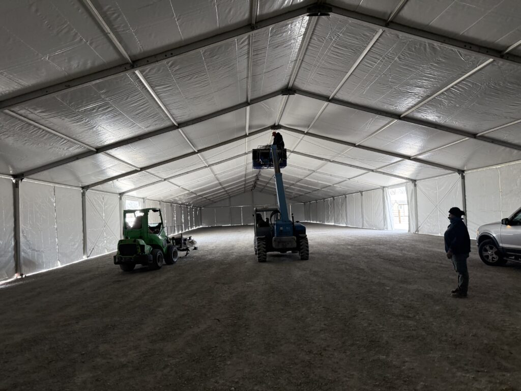 Adding UFO lights using a telehandler under the 60' x 230' (18m x 70m) Losberger clearspan in Kalona, Iowa - Kalona Special Workhorse Sale