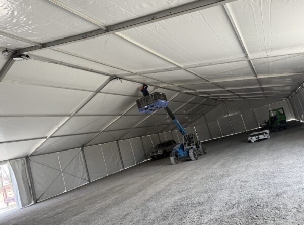 Crew working on UFO lights under the Under the 60' x 230' (18m x 70m) Losberger clearspan in Kalona, Iowa - Kalona Special Workhorse Sale Crew working on UFO lights under the Under the 60' x 230' (18m x 70m) Losberger clearspan in Kalona, Iowa - Kalona Special Workhorse Sale