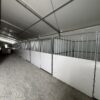 Under 60' x 230' (18m x 70m) Losberger Clearspan Event Structure with horse stalls at the Kalona Sales Barn.