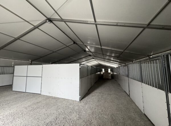 Under 60' x 230' (18m x 70m) Losberger Clearspan Event Structure with horse stalls at the Kalona Sales Barn. Under 60' x 230' (18m x 70m) Losberger Clearspan Event Structure with horse stalls at the Kalona Sales Barn.