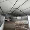 Under the 49' x 66' (15m x 20m) Liri Clearspan structure (tent) with horse stalls at Kalona Sales Barn