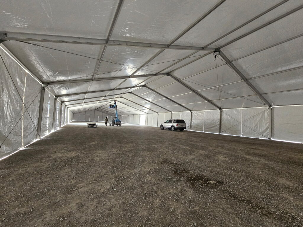 Under the 60' x 230' (18m x 70m) Losberger temporary clearspan structure (tent) for rent.
