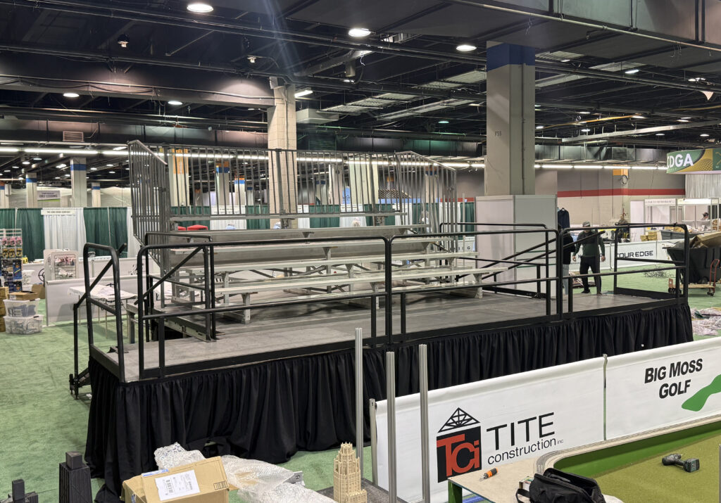 Elevated bleacher (5-row breakdown bleacher that seats 50-people on a 16' x 16' x 34" stage) at the Chicago Golf Show® at Donald E. Stephens Convention Center in Rosemont, Illinois