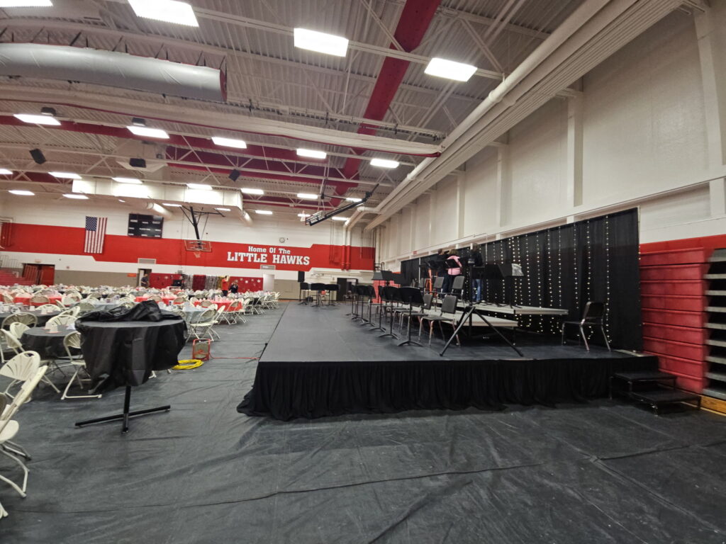 Side of the 20' x 40' stage with a pipe and drape backdrop at Iowa City High School in Iowa City, IA