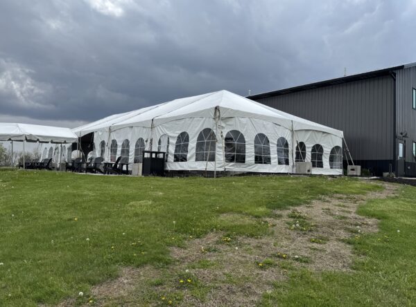 30′ x 75′ frame tent with a 10′ x 30′ frame tent off the left side. 30′ x 75′ frame tent with a 10′ x 30′ frame tent off the left side.