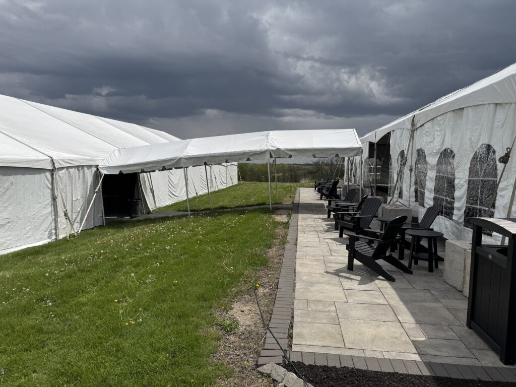 40′ x 120′ Hybrid Tent on the left with 10′ x 30′ Frame Tent walkway into 30′ x 75′ Frame Tent on the right.