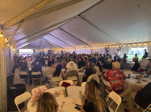 A crowd of people seated at round tables under a 40′ x 120′ Jumbo Track event tent in Iowa. A crowd of people seated at round tables under a 40′ x 120′ Jumbo Track event tent in Iowa.