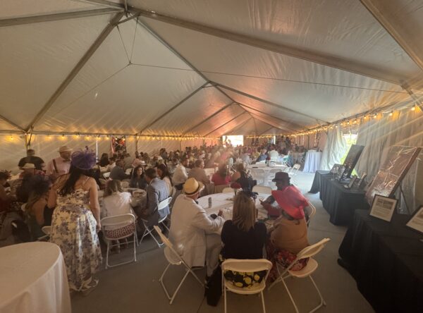 Back corner with a crowd of people seated at round tables under a 40′ x 120′ Jumbo Track event tent in Iowa. Back corner with a crowd of people seated at round tables under a 40′ x 120′ Jumbo Track event tent in Iowa.