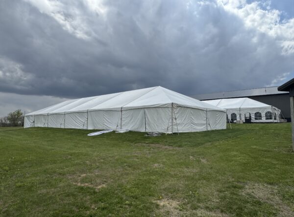 Back of 40′ x 120′ Hybrid Tent on the left with a 30′ x 75′ Frame Tent in the background. Back of 40′ x 120′ Hybrid Tent on the left with a 30′ x 75′ Frame Tent in the background.