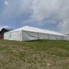 Corner of 40′ x 120′ Hybrid Tent with solid sidewalls.