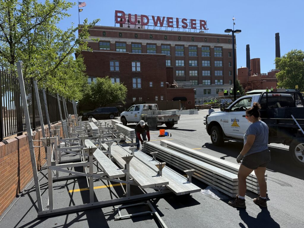 Crew setting up 5-Row bleachers with Railing outside of the Budweiser building for the 150th Anniversary Celebration in St. Louis, Missouri