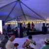 Stage under a 40' x 120' Jumbo Track event tent.