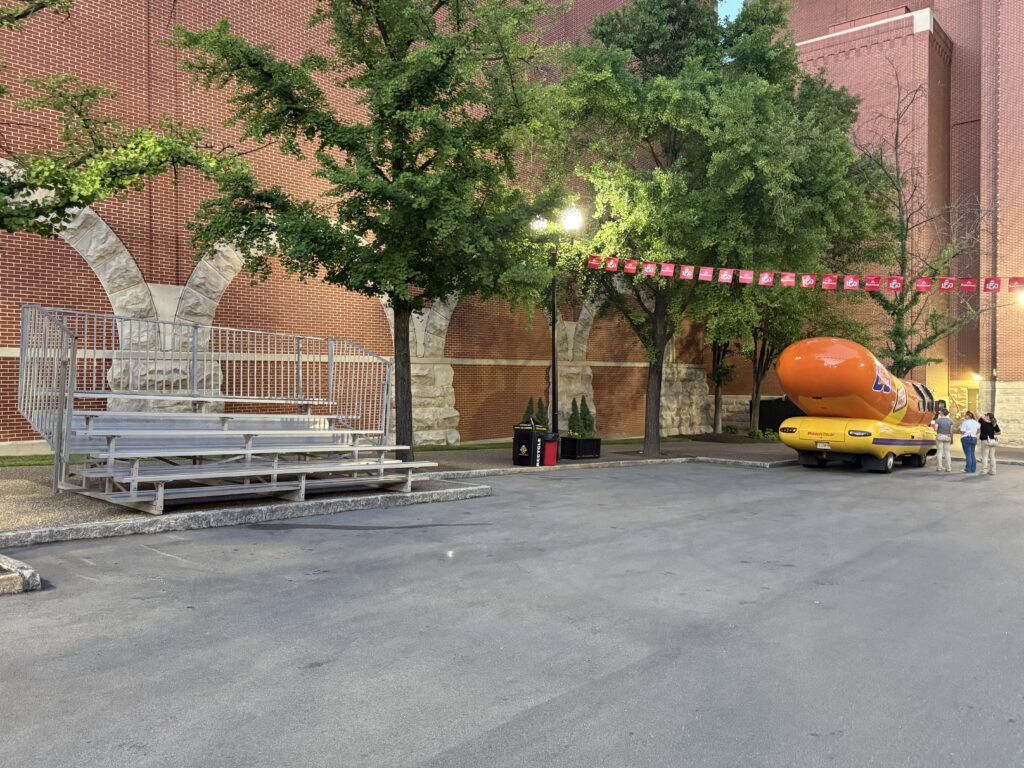 The Wienermobile and one of our 5-row bleachers with railing outside of the Budweiser building for the 150th Anniversary Celebration in St. Louis, Missouri