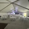 Under the 40′ x 120′ Hybrid Jumbotrac Event Tent with tables and chairs.