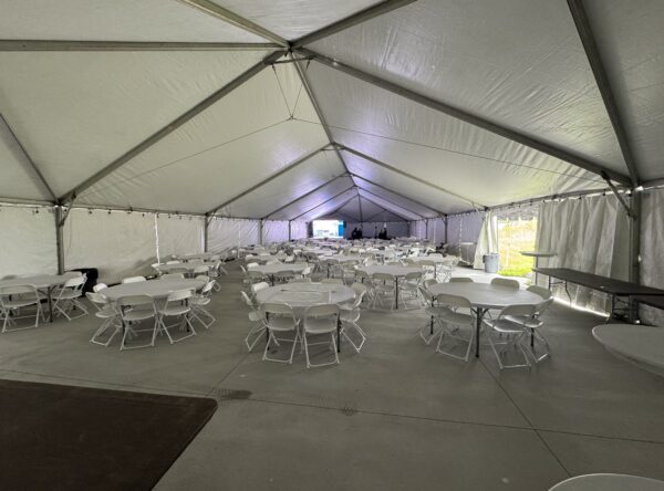 Under the 40′ x 120′ Hybrid Jumbotrac Event Tent with tables and chairs. Under the 40′ x 120′ Hybrid Jumbotrac Event Tent with tables and chairs.