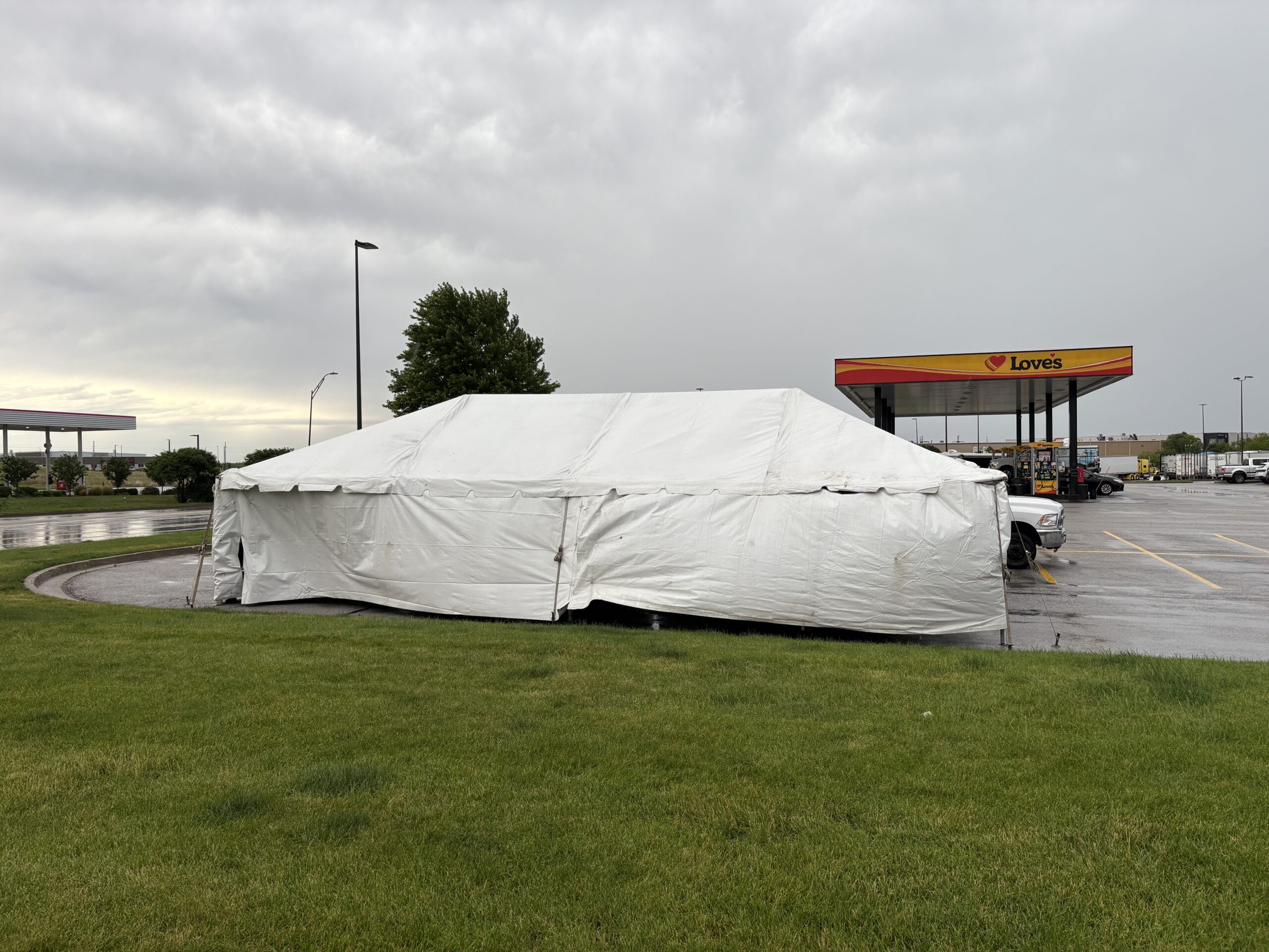 20' x 40' frame tent setup in the Quad Cities. White sidewalls installed for TNT Fireworks to protect inventory and customers from rain or wind — fully adjustable based on weather conditions.