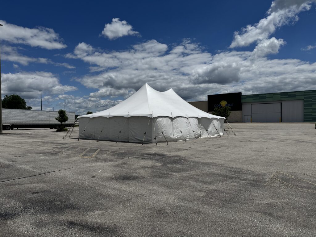 30' x 40' Rope & Pole Tent Setup on Asphalt at Coral Ridge Mall for TNT Fireworks (corner of tent with mall sign)