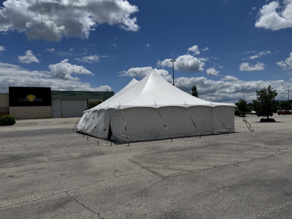 30' x 40' Rope & Pole Tent Setup on Asphalt at Coral Ridge Mall for TNT Fireworks (end with mall sign)