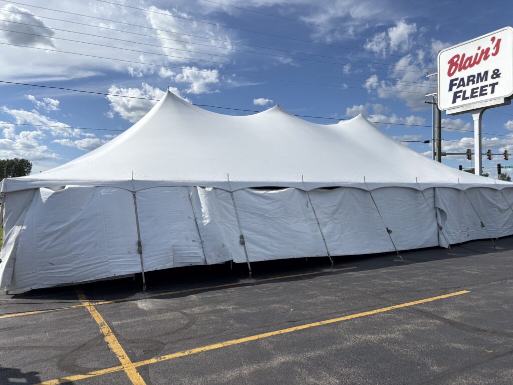 30' x 60' Rope and Pole Tent in Sterling, Illinois for Cornellier Fireworks with Blair's Farm & Fleet sign (close-up)