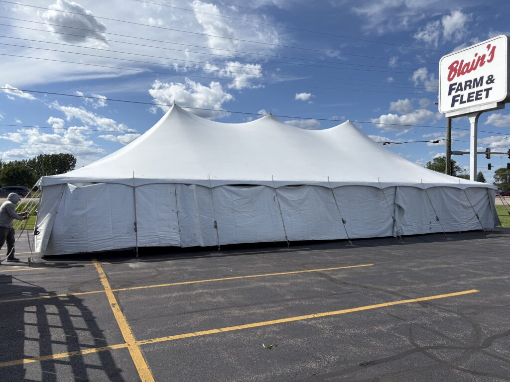 30' x 60' Rope and Pole Tent in Sterling, Illinois for Cornellier Fireworks with Blair's Farm & Fleet sign (close-up)