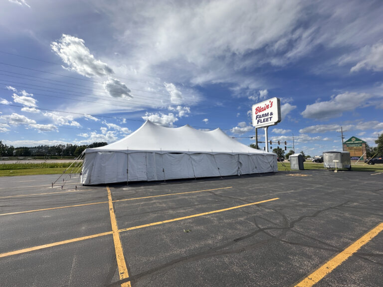 30' x 60' Rope and Pole Tent in Sterling, Illinois for Cornellier Fireworks with Blair's Farm & Fleet sign (edit)