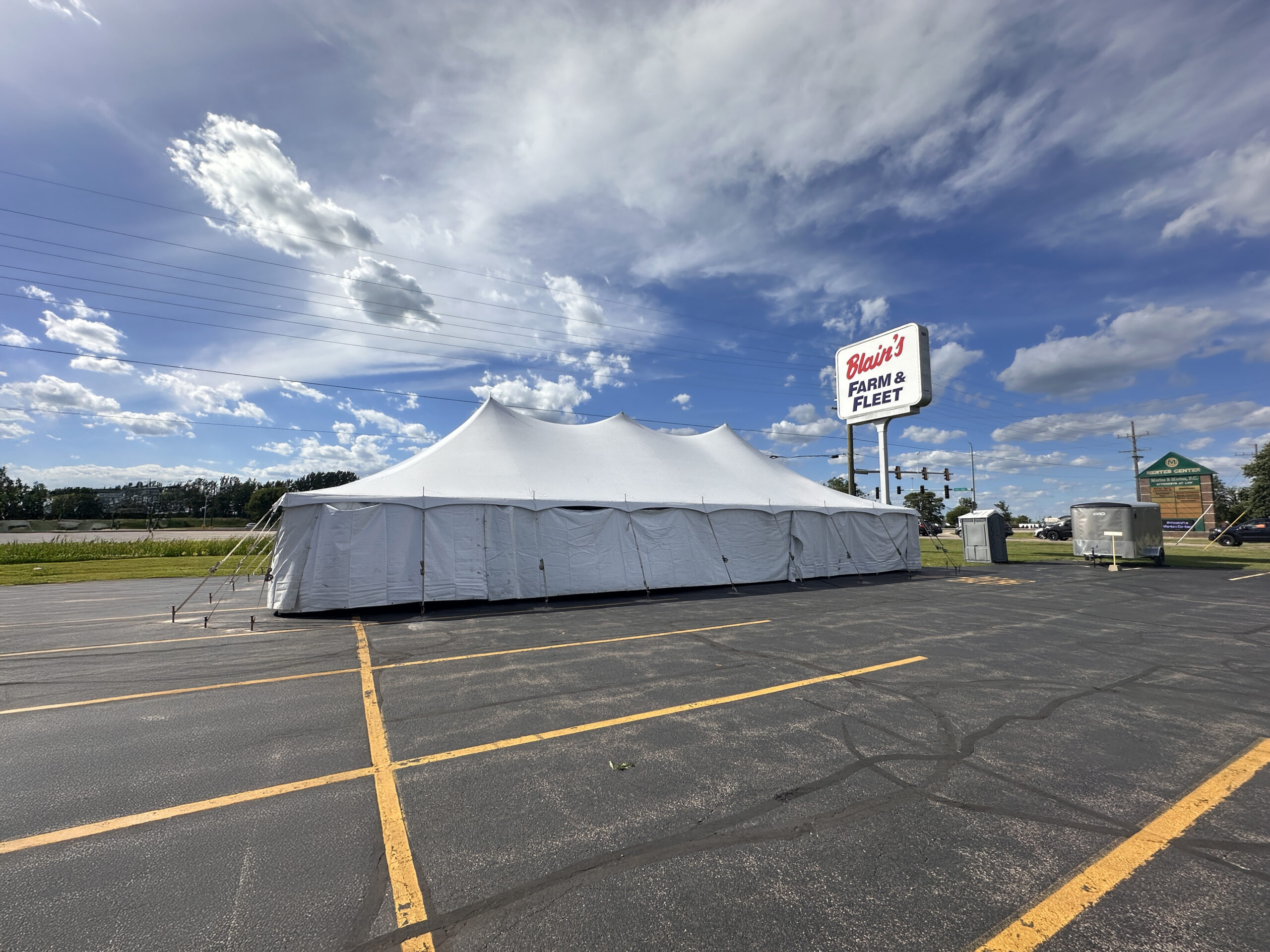 30' x 60' Rope and Pole Tent in Sterling, Illinois for Cornellier Fireworks with Blair's Farm & Fleet sign (edit)