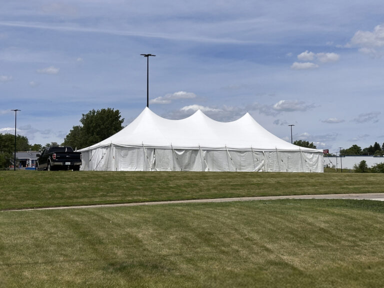 30' x 60' Rope and Pole tent (staked) with tables, and sidewalls in Freeport, Illinois for Cornelier Fireworks.