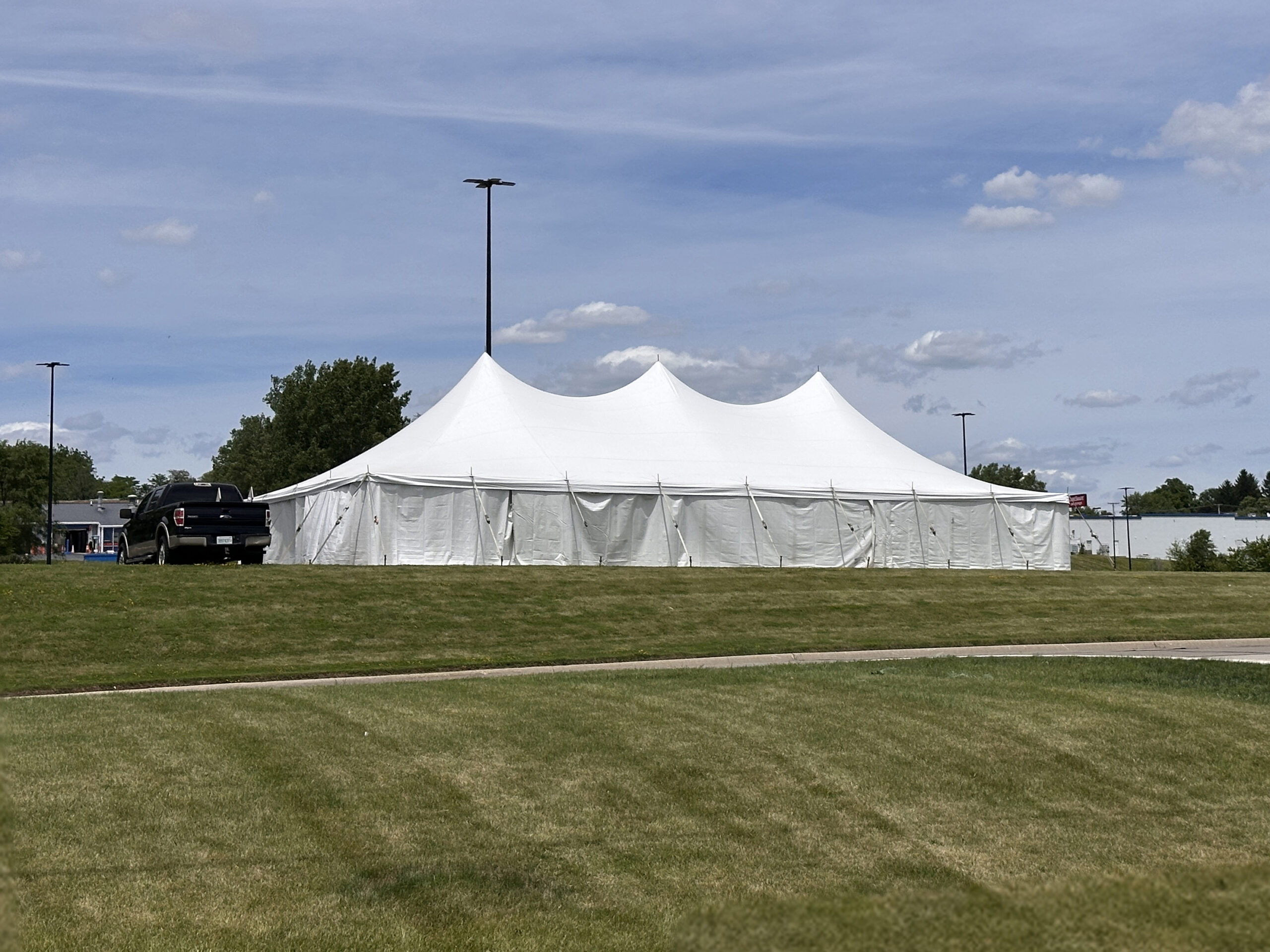 30' x 60' Rope and Pole tent (staked) with tables, and sidewalls in Freeport, Illinois for Cornelier Fireworks.