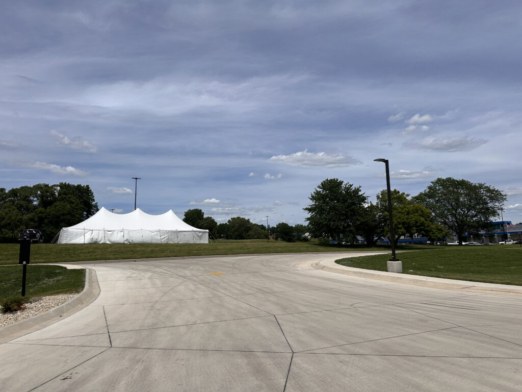 30' x 60' Rope and Pole tent (staked) with tables, and sidewalls in Freeport, Illinois for Cornelier Fireworks (far)