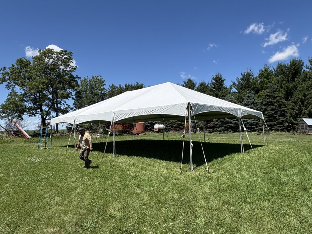 Big Ten Rentals crew member completing setup of the spacious 30' x 45' frame tent in Keota, Iowa.
