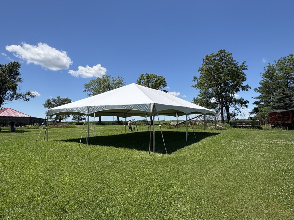 Corner perspective of the 30x45 frame tent showing full structure and setup crew in Keota, Iowa.