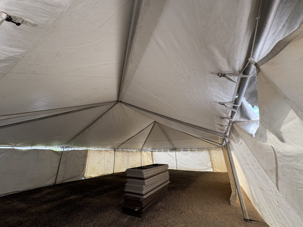 Under the 30' x 45' Frame Tent and tables in Hiawatha, Iowa for Cornelier Fireworks