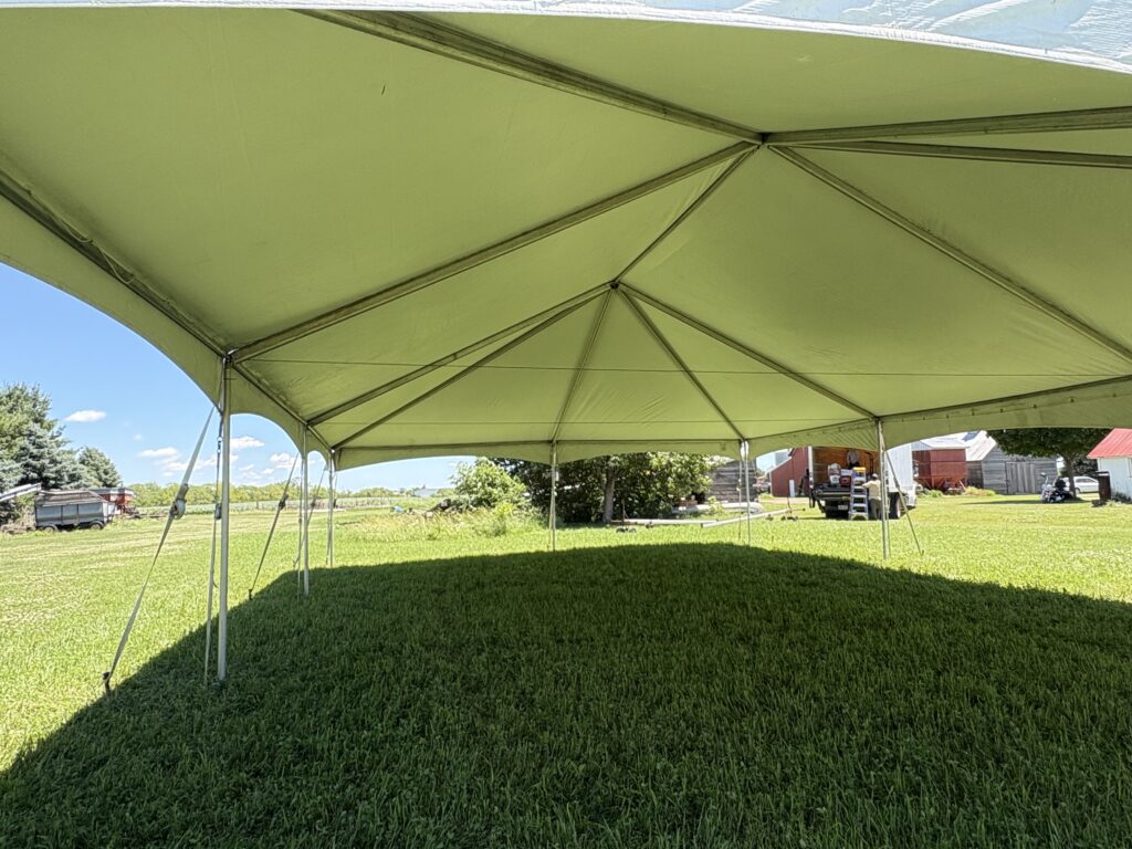 View from under the 30' x 45' frame tent – clear open space with no center poles, perfect for wedding receptions.