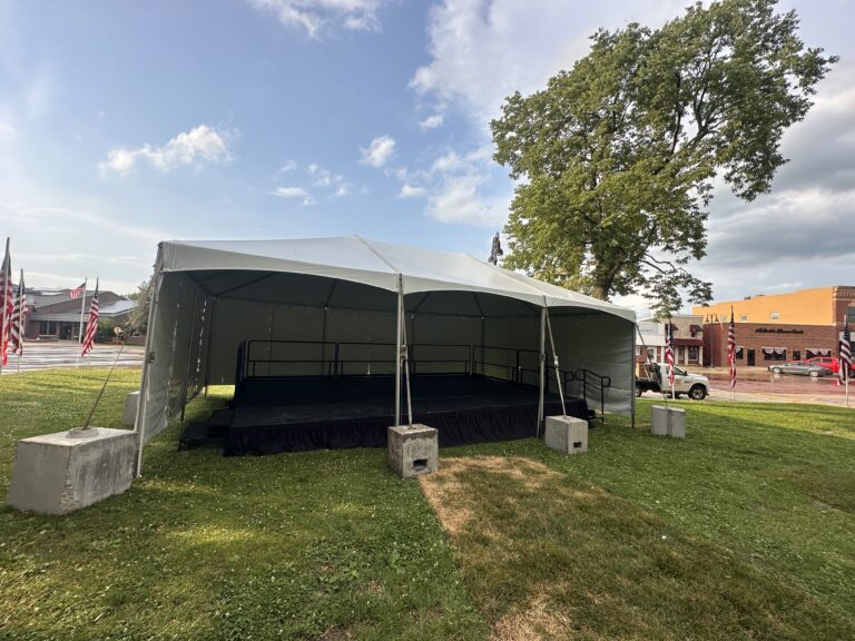 20' x 30' Frame Event Tent with a 16' x 24' Stage under it in Williamsburg, Iowa