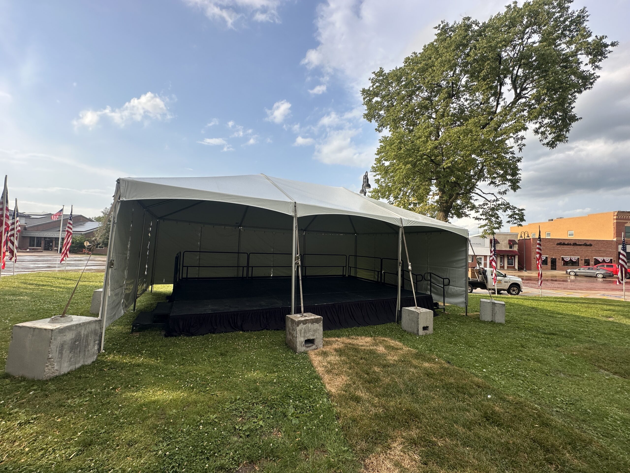 20' x 30' Frame Event Tent with a 16' x 24' Stage under it in Williamsburg, Iowa