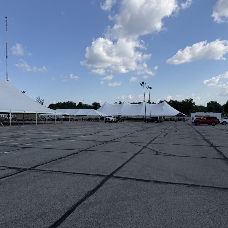 80' x 90' rope and pole tent (left), 30' x 75' frame tent, and 80' x 150' twin pole rope and pole tent in the back in Cedar Rapids, Iowa