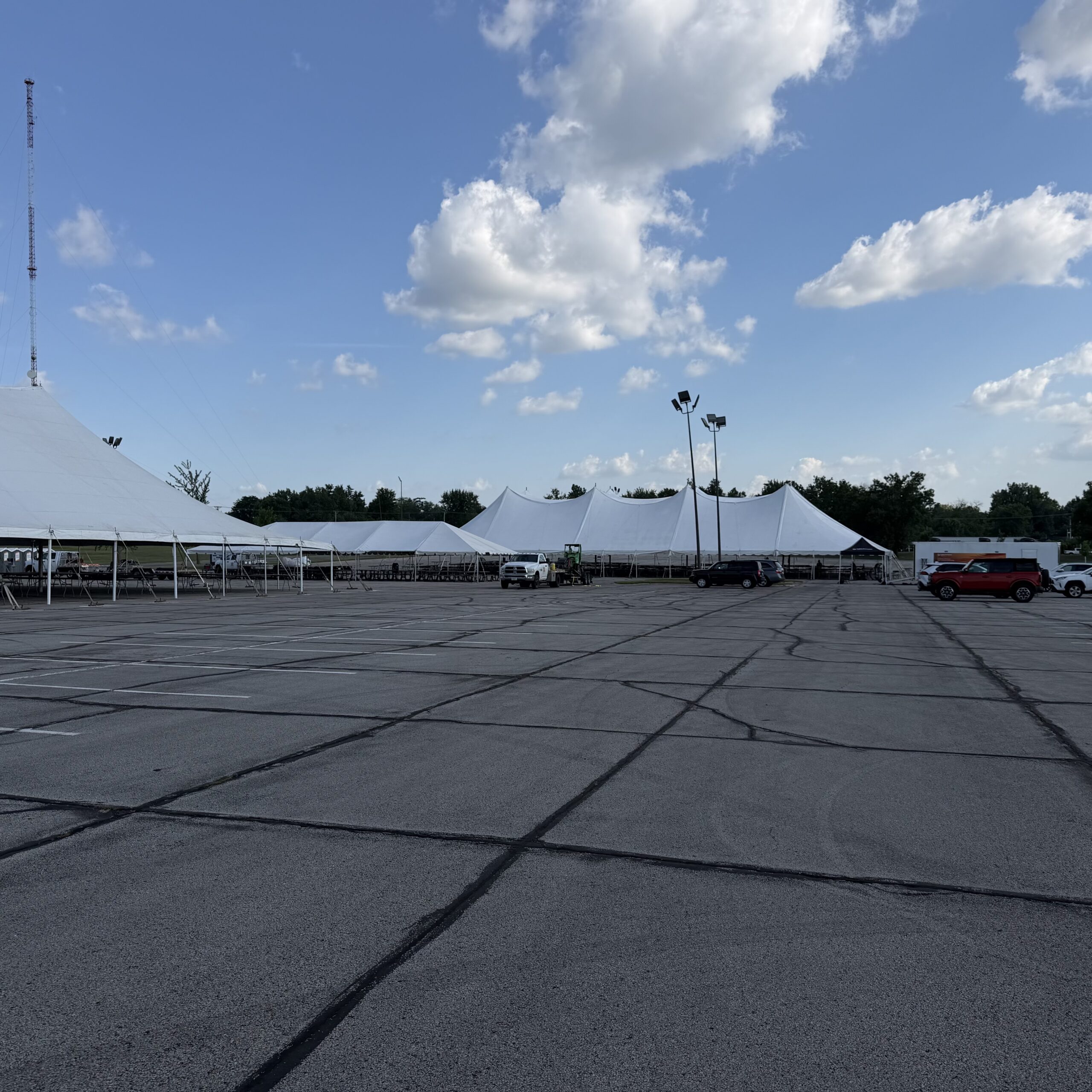 80' x 90' rope and pole tent (left), 30' x 75' frame tent, and 80' x 150' twin pole rope and pole tent in the back in Cedar Rapids, Iowa