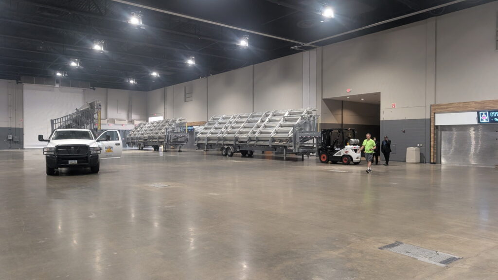 Big Ten Rentals 45-foot towable bleachers being positioned along the wall inside the Schaumburg Convention Center for the WTSDA World Championships.