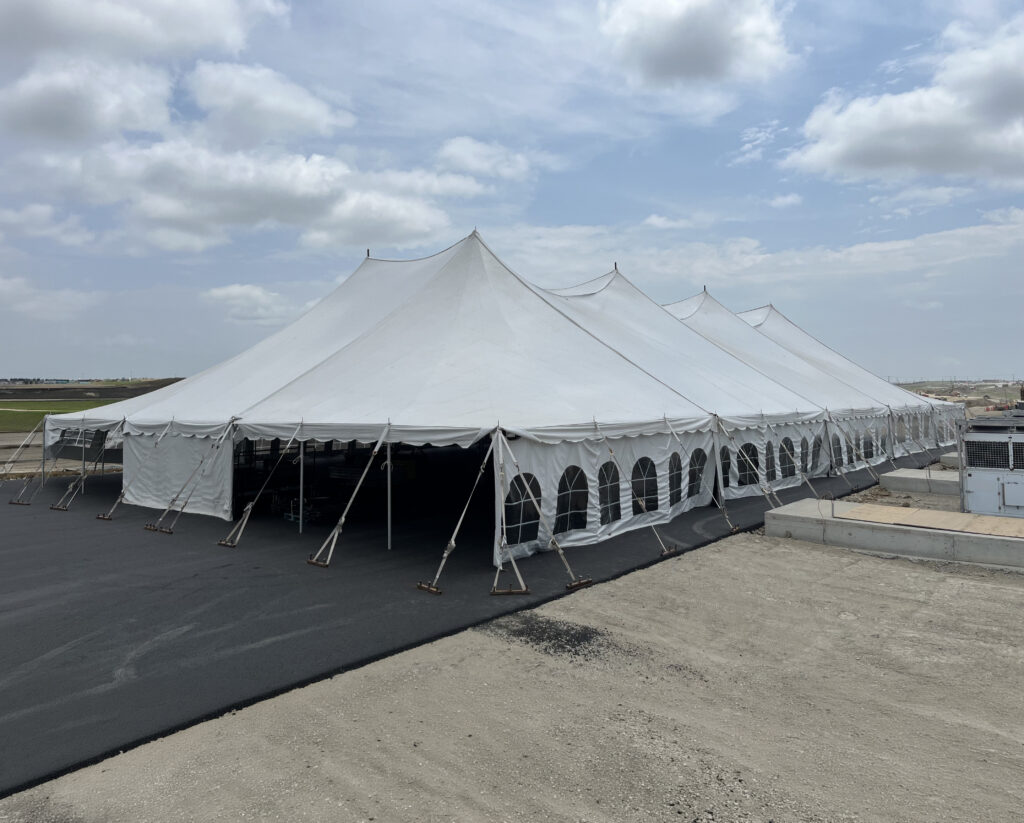 Outside of 80' x 150' rope and pole event tent at a construction site in Iowa.