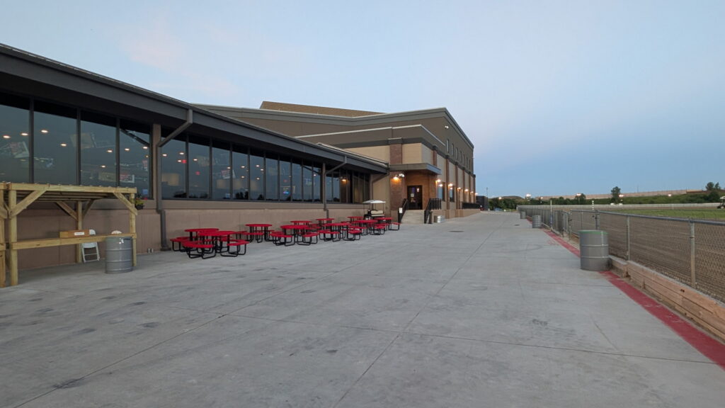 WarHorse Casino Building with Outdoor Patio, Picnic Tables, and Race Track